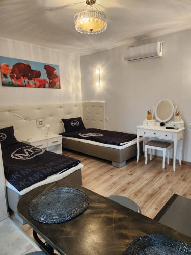 a room with two beds and a table in it at Noclegi Gracja in Wałbrzych
