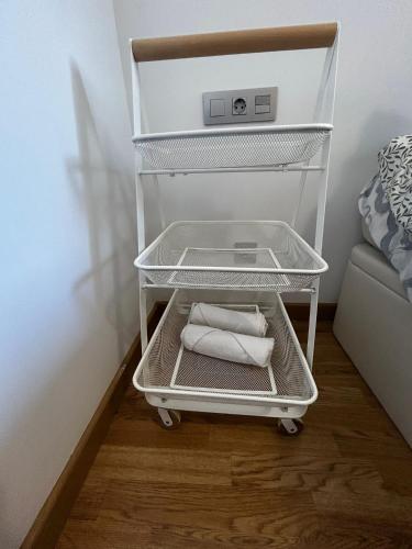 a towel rack with two towels in a bedroom at Malpica Beach in Malpica