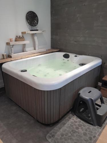 a large bath tub sitting in a room at Au delà des Remparts in Montreuil-sur-Mer