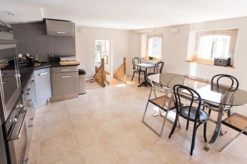 une cuisine et une salle à manger avec une table et des chaises dans l'établissement Chambres d’Hôtes La Chance au Roy, à Aigneville