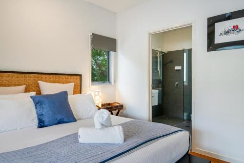 a bedroom with a king sized bed and a shower at Aaman & Cinta Luxury Villas in Byron Bay