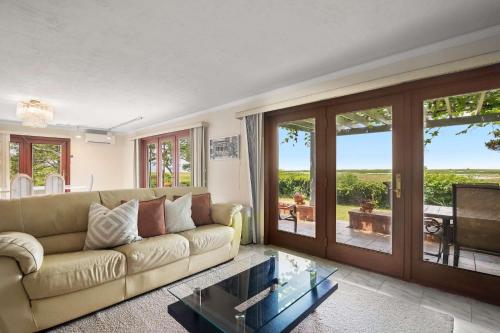 a living room with a couch and a glass table at Tenth of a Mile Walk to Boat Meadow Landing in Eastham