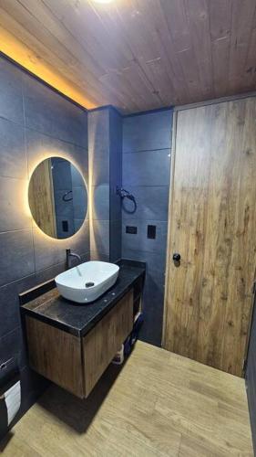 a bathroom with a sink and a mirror at Villa Encanto Tuta Chalet de Lujo con Chimenea y Vistas 360º in Tuta