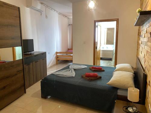 a bedroom with a bed with two pillows on it at XL Central Home - Sleeps 10 people in Pieta