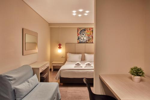 a room with a bed and a desk and a chair at Athens Way Pop Art Hotel in Athens