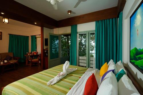 a bedroom with a bed with a bird on it at Blackberry Hills Munnar Nature Resort & Spa in Munnar