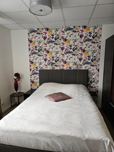 a bedroom with a large bed with a floral wallpaper at Olivin Kytlice in Kytlice
