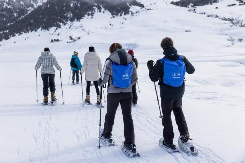 a group of people on skis in the snow at RVHotels Tuca in Vielha