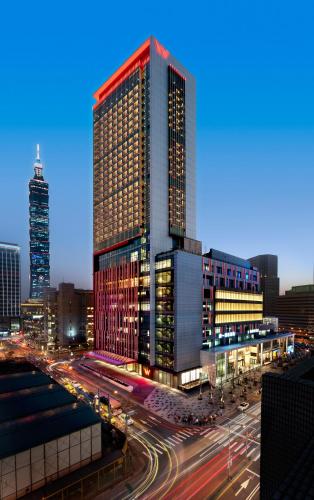 a tall building in a city at night with traffic at W Taipei in Taipei