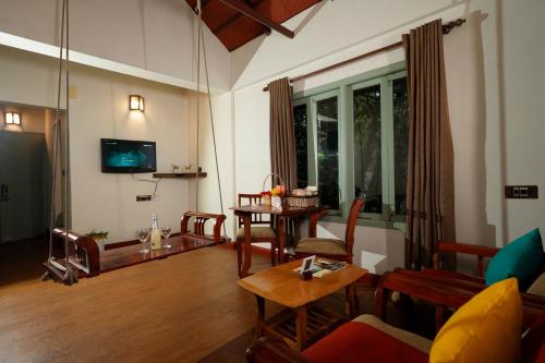 a living room with a couch and a table at Blackberry Hills Munnar Nature Resort & Spa in Munnar