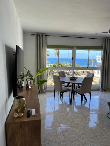 a living room with a dining table and a view of the ocean at CORNELIAS HOME TC3 Atico in Los Cristianos