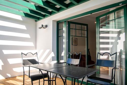 a dining room with a table and chairs at Villa Aitama in Cap-Ferret