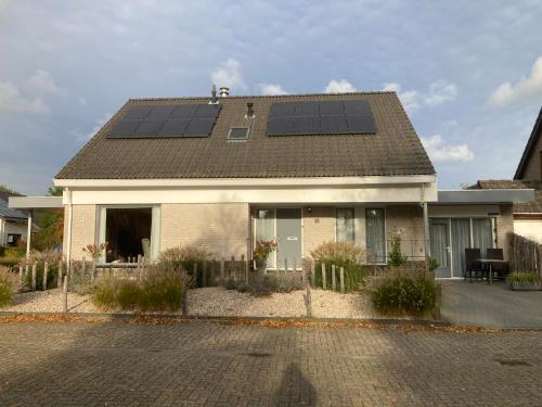 a house with solar panels on the roof at Studio Lodo in Middelburg
