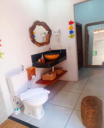 a bathroom with a white toilet and a sink at Flats Macapá Meu Amor 10 in Luis Correia