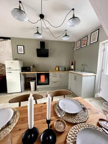 a kitchen with a wooden table with candles on it at TudorRose Townhouse - A New Unique Town Centre Home in King's Lynn
