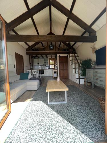 a living room with a couch and a table at El almacén de Lola Relax, piscina y Vistas al Mar in Pontevedra