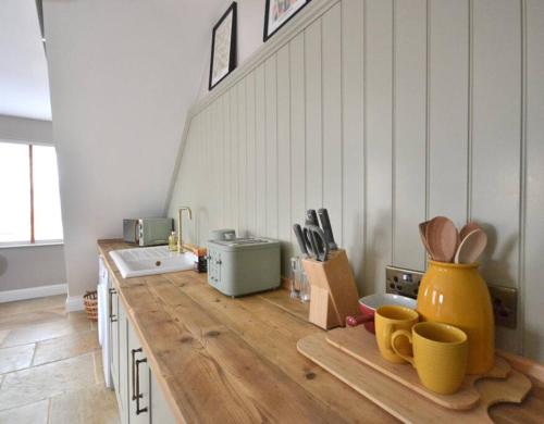 a kitchen with a wooden counter top with utensils at St Nicholas Corner - A New Unique Town Centre Home in King's Lynn
