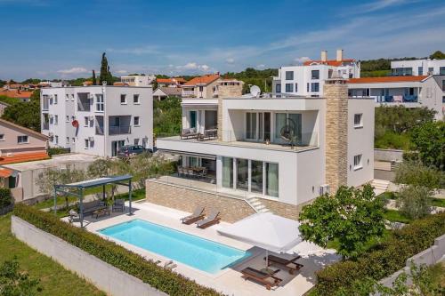an aerial view of a house with a swimming pool at Villa Milagros in Kožino