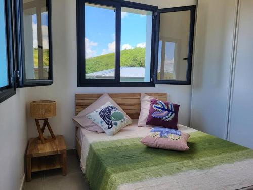 a bedroom with a bed with two pillows on it at SALTY LODGE Villa 3 chambres piscine "ALIZES" - Pointe Faula in Le Vauclin