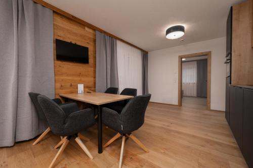 a conference room with a wooden table and chairs at A CASA Türkis in Sölden
