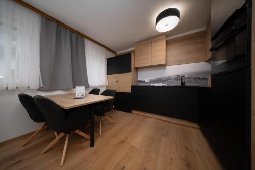 a dining room with a table and some chairs at A CASA Türkis in Sölden
