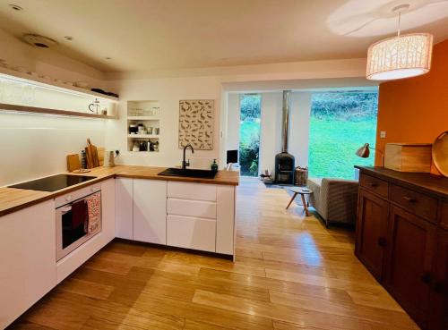 una cucina con mobili bianchi e una grande finestra di 4 Balvaig Cottage a Stirling