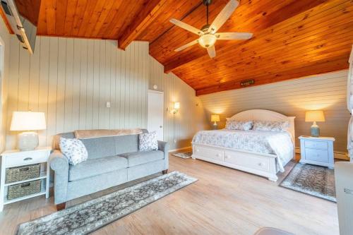a bedroom with a bed and a couch at ADK Whiteface Chalet with Hot Tub, Dog Friendly! in Wilmington