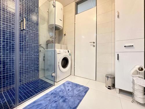 a washing machine in a bathroom with a glass door at Sarajevo center in Sarajevo