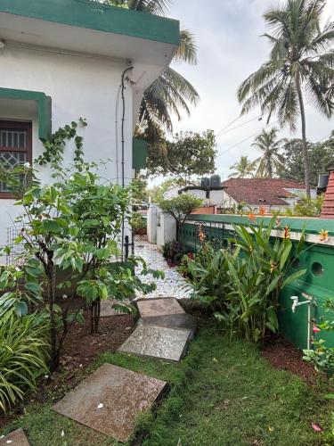 a house with a green train on the side of it at Angelina guest house, Anjuna Beach Road in Anjuna
