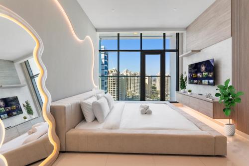 a bedroom with a large bed with a large window at Seven Palm Hotel with West beach access in Dubai