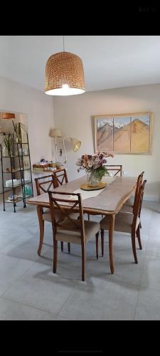 a dining room with a table and chairs and a lamp at Las Valentinas Hospedaje de Montaña in Chilecito