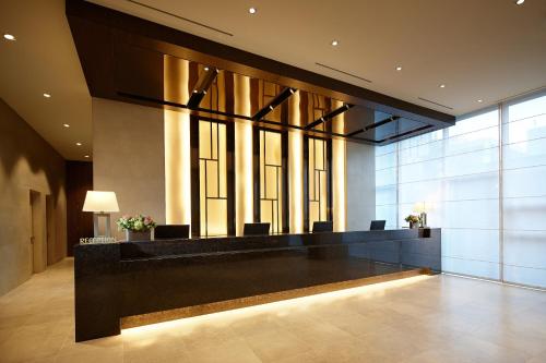 a lobby with a reception desk in a building at LOTTE City Hotel Myeongdong in Seoul