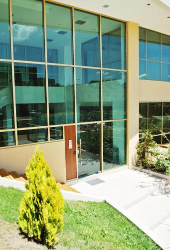 an office building with a tree in front of it at Albar Club de Mar in Pinamar