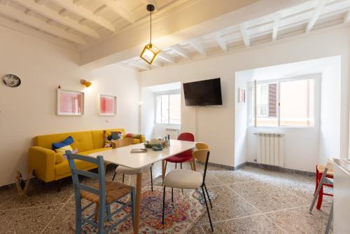 ein Wohnzimmer mit Tisch, Stühlen und Sofa in der Unterkunft Perduta a Rome in Rom