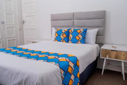 a bedroom with a large bed with a colorful comforter at The Cozy Corner Luxury Living in Nchesi