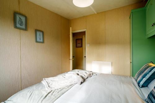 a bedroom with a bed and a lamp in it at Peaceful 3-Bed Lodge ! Ideal for Families! in Warton