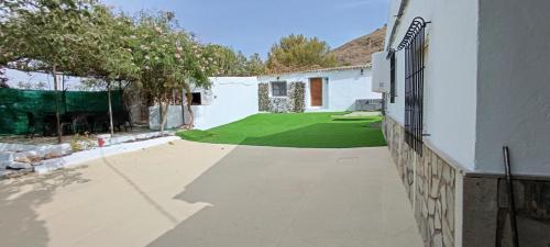 a courtyard of a house with a green lawn at La Jordana 39, Calblanque in Las Barracas