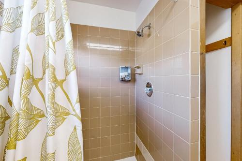 a bathroom with a shower with a shower curtain at The Manatee Cove - Side B: Studio in Cocoa