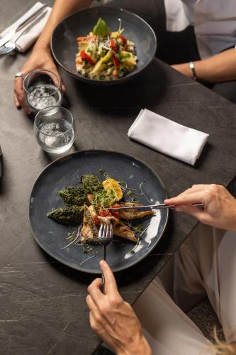 two people sitting at a table with plates of food at Idou Anfa Hôtel & Spa in Casablanca