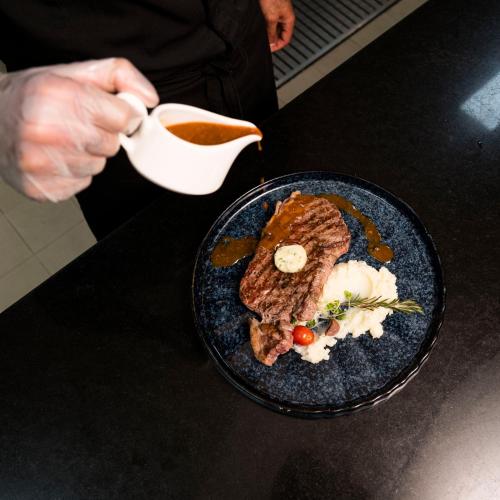 a person holding a cup of tea next to a plate of food at Idou Anfa Hôtel & Spa in Casablanca