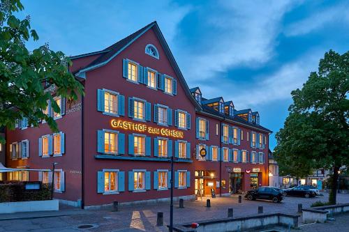 a large red building with a sign on it at Hotel Gasthof zum Ochsen in Arlesheim