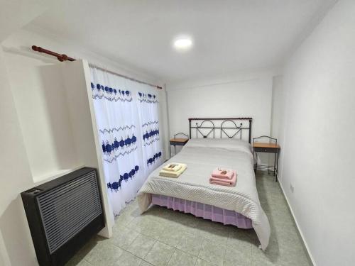 a bedroom with a bed and a tv in it at Departamentos aćawaia in Ushuaia