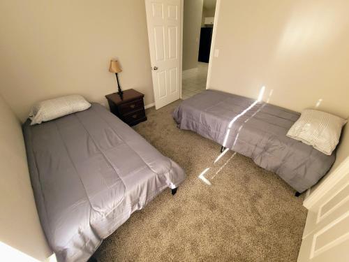 a bedroom with two beds and a lamp in it at Fresh CrashPads 2 in Houston