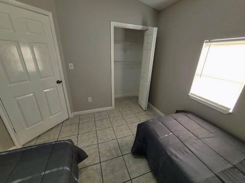 a bedroom with a bed and a window and a closet at Fresh CrashPads 2 in Houston