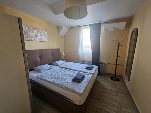 a bedroom with a bed with a blue blanket at Royal Apartments & Rooms in Zagreb