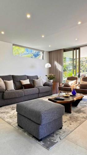 a living room with a couch and a table at Cardais Paradise View in São Vicente
