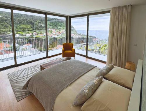 a bedroom with a bed and a large window at Cardais Paradise View in São Vicente