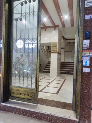 an entrance to a building with a glass door at AL SHAMS MUSCAT MALE hostel in Muscat