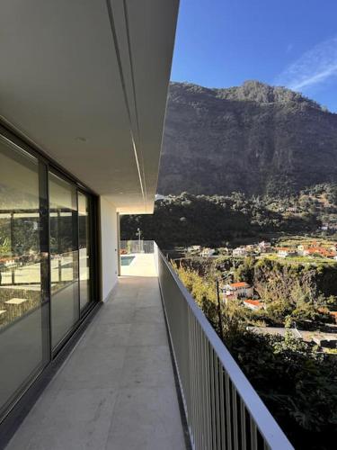 a balcony of a house with a view of a mountain at Cardais Paradise View in São Vicente