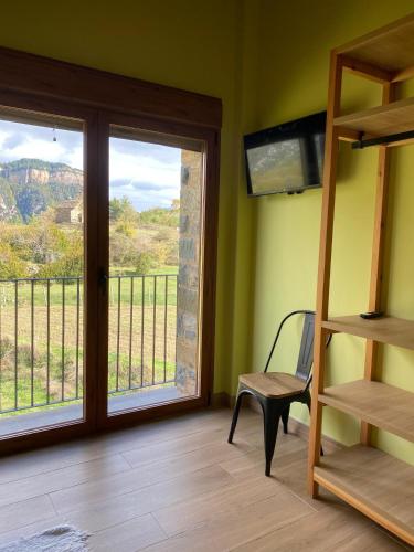 a room with a balcony with a view of the mountains at As Fuebas de Patricio in Vío
